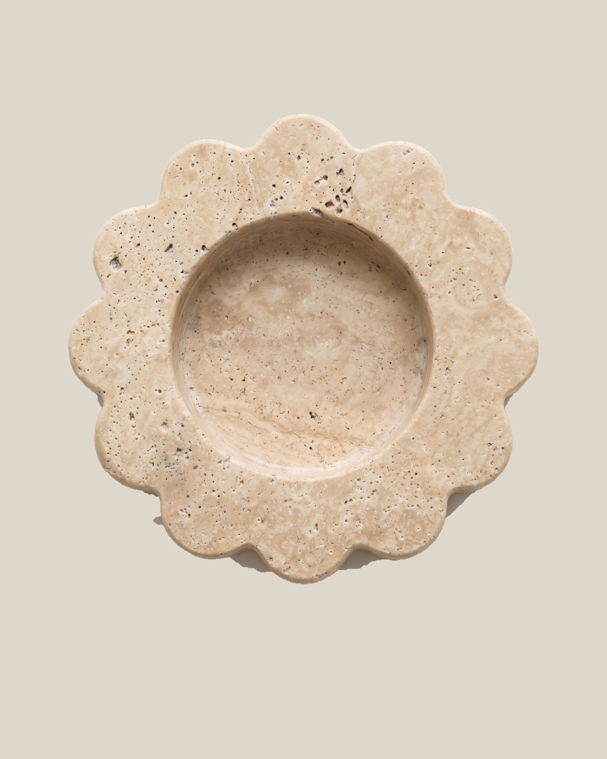 ATOMS Mini Sun Tray in Travertine Beige, near-top view on BONE background; 12.5 cm diameter and 2 cm thick.