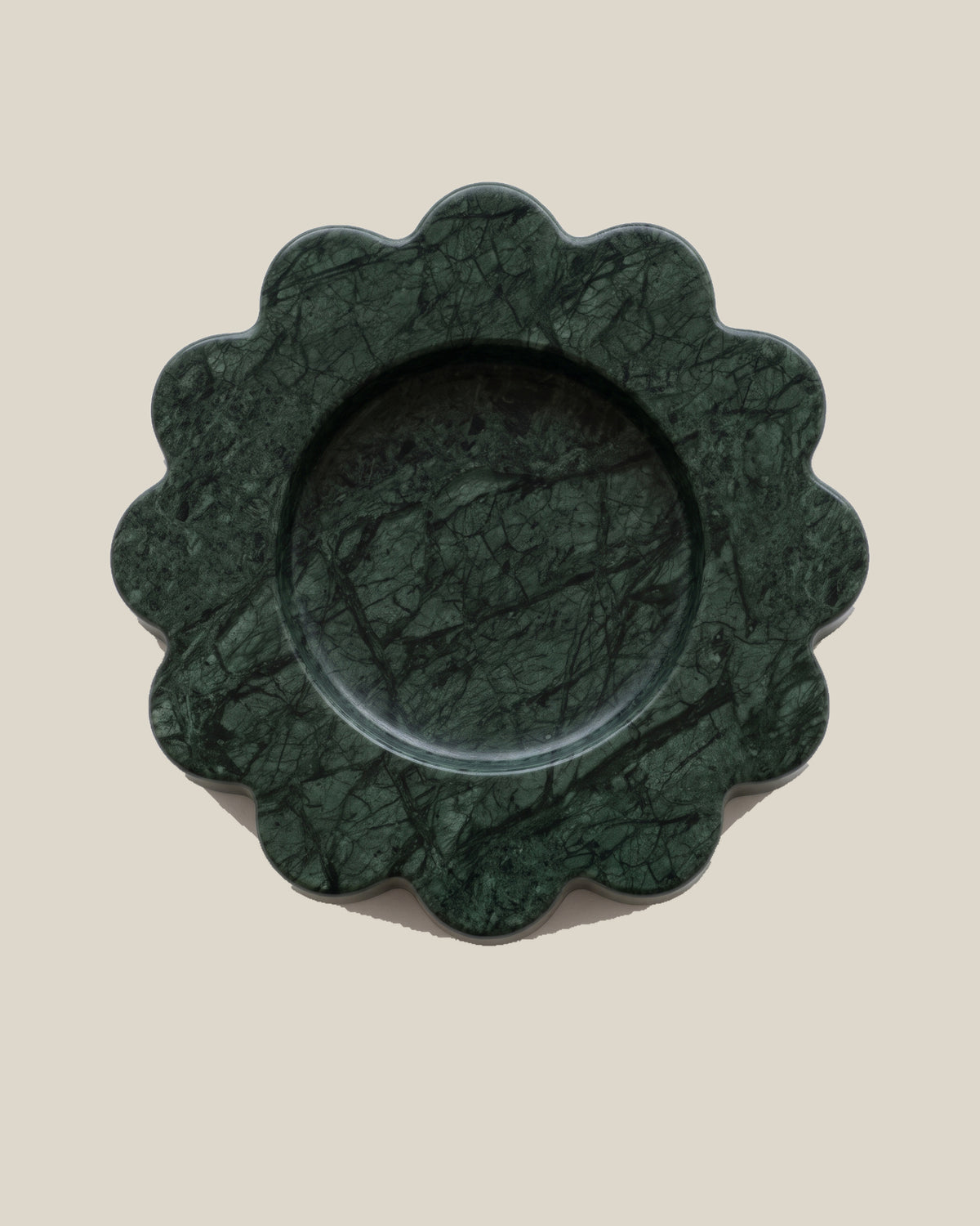 ATOMS Mini Sun Tray in Verde Marble, near-top view on BONE background; 12.5 cm diameter and 2 cm thick.