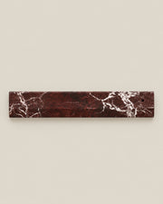 Overhead view of LINEA Incense Holder in Rosso Levante marble.