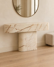 BUTTER console table by CARVINGS in Sofita Beige Marble, in a styled interior, left view.