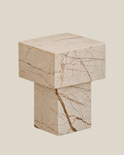 BUTTER side table by CARVINGS in Sofita Beige Marble, on a BONE background, left view.