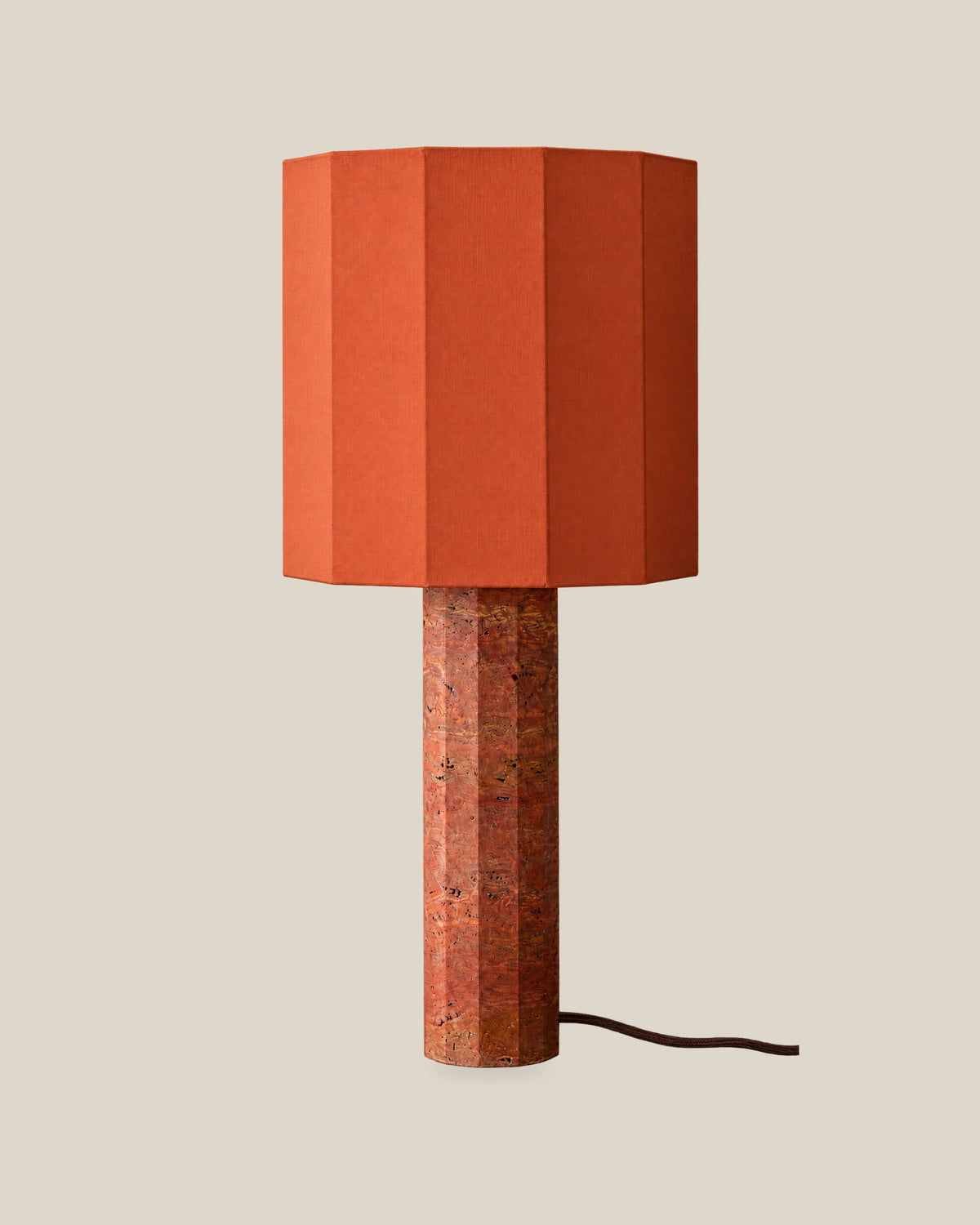 Roma Table Lamp, Large Faceted, Travertine Red + Terracotta, on a bone background.