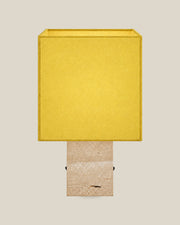 Roma Table Lamp, Small Square, Travertine Beige + Yellow, front hero view on bone background.