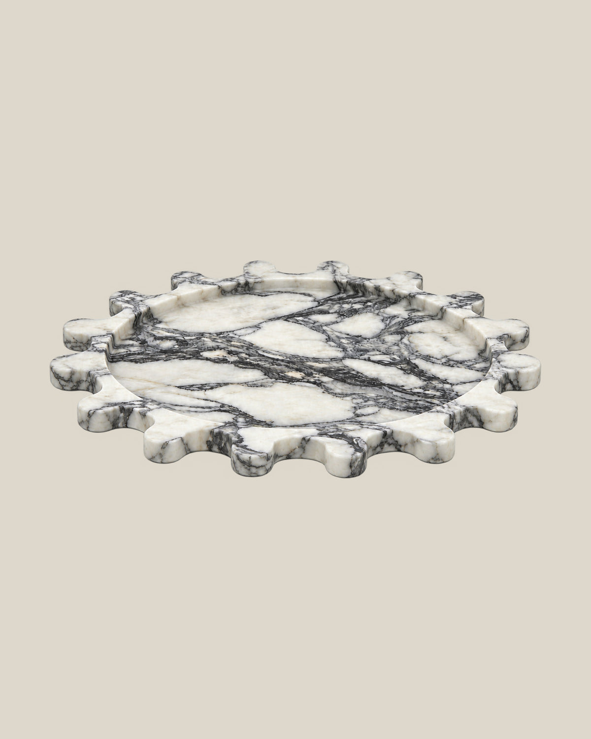 Sun Orbit Tray in Arabescato natural marble, low front view, rounded sun rays and recessed circular centre.